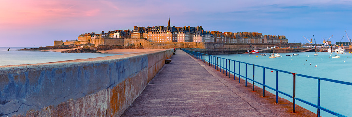 Panoramic view of walled city Saint-Malo with St Vincent Cathedral at sunset. Saint-Maol is famous port city of Privateers is known as city corsaire, Brittany, France