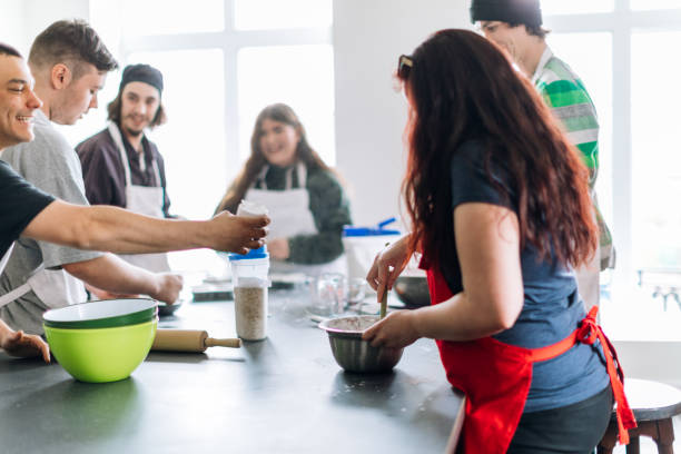 istock Group of people learning to cook in a community center workshop. Cooking class 962604086