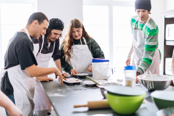 istock Group of young adults cooking in a community center workshop 962604168