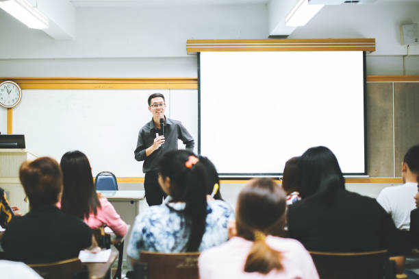 teacher teaching studen in classroom at university. - studen imagens e fotografias de stock