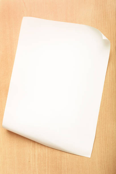 istock White paper with fold inside corner on wood background 962606440