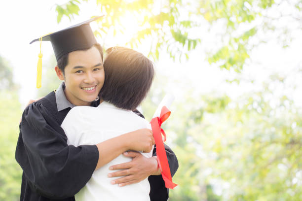 istock Happy Graduate hug celebrating with parent 962607784