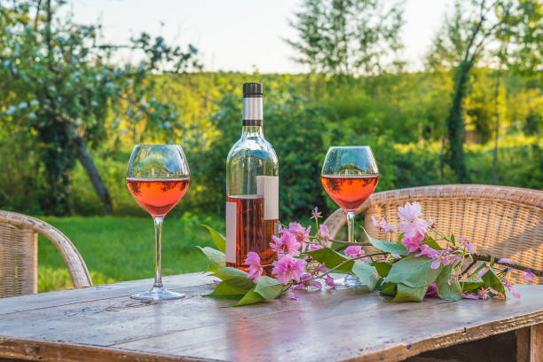 istock Art of living: Bottle of pink wine and two wineglasses 962608748