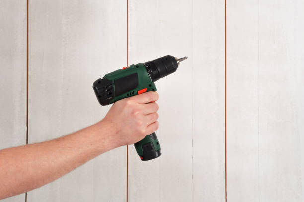 istock Male Hand Holding Cordless Drill 962611134