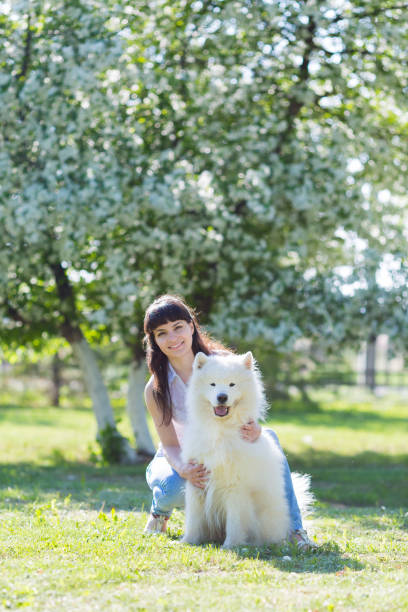 istock The brunette girl with a big white dog. 962614162