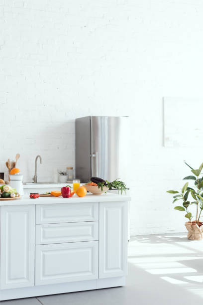 istock interior of light modern kitchen with fruits and vegetables on kitchen counter 962620206