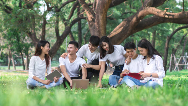 istock Six students are making group reports to send instructors. People meeting team in the park outdoors. Concept of education, together, teamwork, learning, information, knowledge and research. 962625262