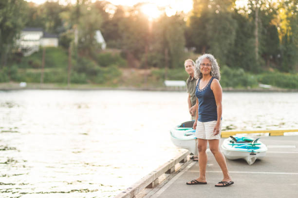 istock Interracial senior couple stand on the dock by their kayaks 962631944