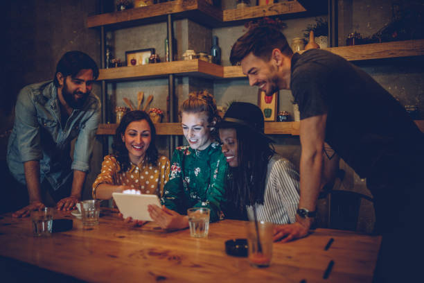 istock Happy friends using tablet at coffee shop 962634212