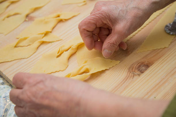 istock closeup of hands working fresh homemade pasta 962638002
