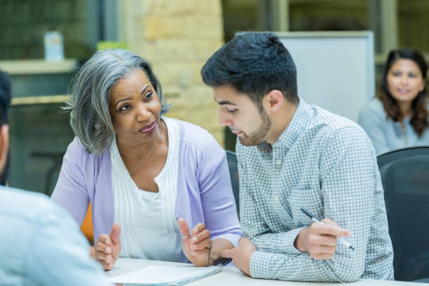 istock Senior woman discusses assignment with university classmate 962638144