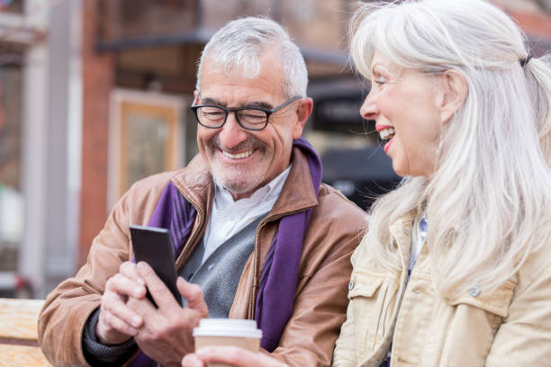 istock Smiling senior couple looking at smartphone 962641814