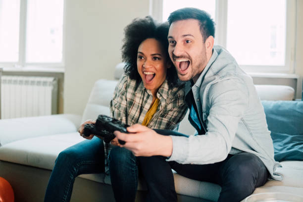 istock Young couple playing video games together 962643572