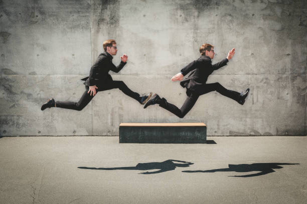 running wild, twin business portrait twin brothers with black suits and glasses running fast in urban surrounding. twin concept. two men same clothes stock pictures, royalty-free photos & images