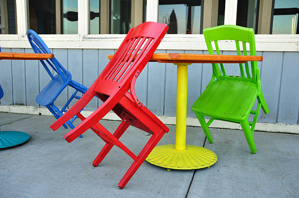 istock Red, Green, and Blue Chairs Leaning on Tables 96264507
