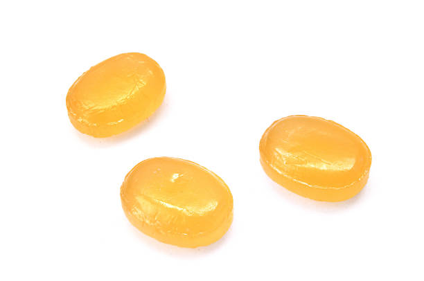 Three Yellow Cough Drops (Throat Lozenges)  cough lozenge stock pictures, royalty-free photos & images