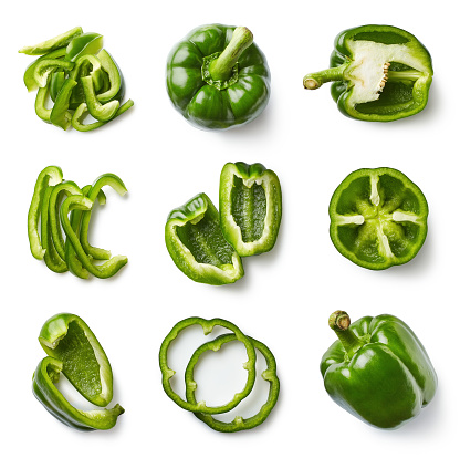 Set of fresh whole and sliced sweet green pepper isolated on white background. Top view