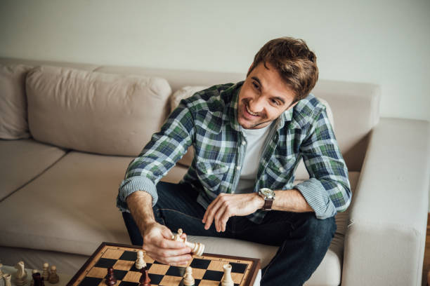 istock Happy young man with chess figurine 962650766