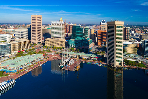 Downtown Baltimore skyline aerial view with Baltimore's Inner Harbor and boats in the foreground.