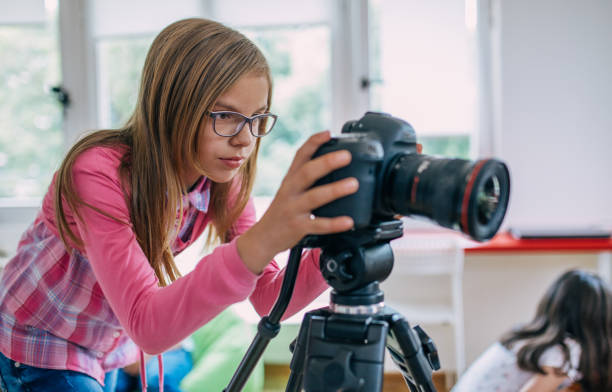 istock Girl teaching how to use digital camera 962654194