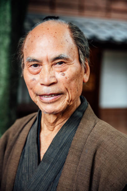 istock Smiling Japanese senior in traditional clothes 962654310