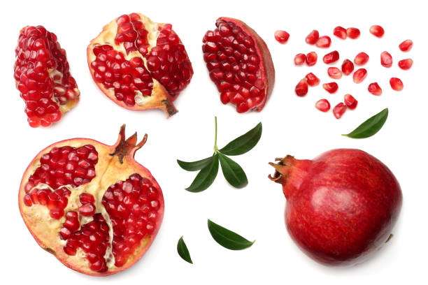 istock pomegranate fruit with seeds and green leaves isolated on white background top view 962655940