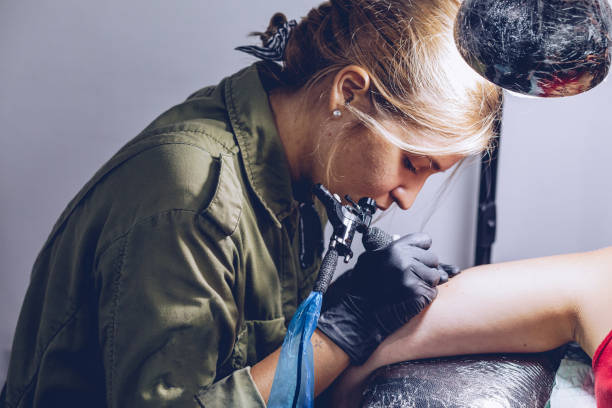 istock Woman getting tattoo 962658888
