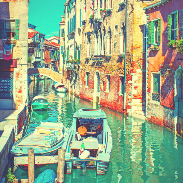 istock Side canal with moored motorboats in Venice 962664658