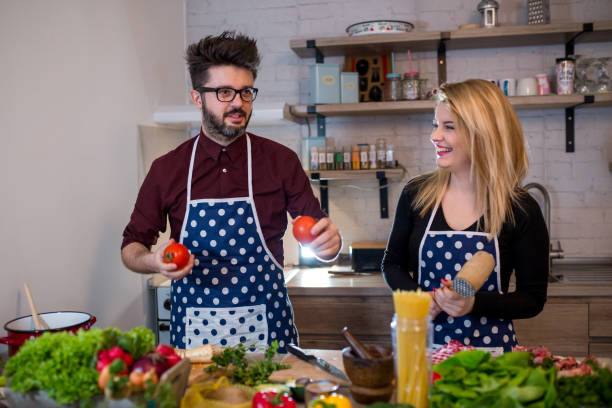istock Smiling young couple cooking food in the kitchen 962664802