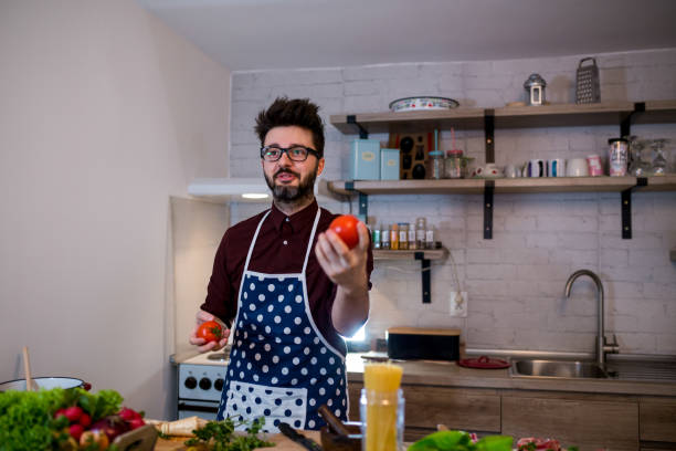 istock Young man cooking romantic dinner at home 962665094