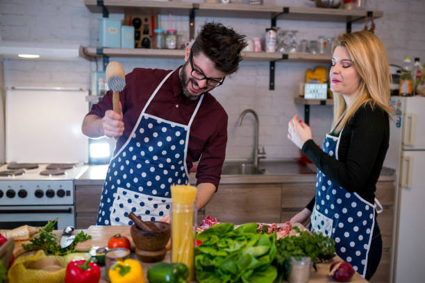 istock Smiling young couple cooking food in the kitchen 962665966
