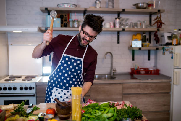 istock Young man cooking romantic dinner at home 962668474