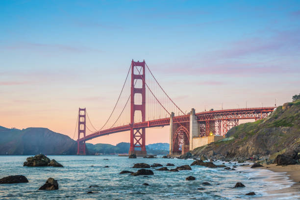 As the sun goes down, enjoy the best view of the Golden Gate Bridge of San Francisco As the sun goes down, enjoy the best view of the Golden Gate Bridge of San Francisco baker beach stock pictures, royalty-free photos & images