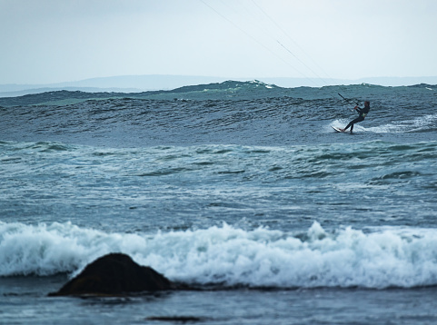 Thirty something man enjoys kite boarding on Nova Scotia's Eastern shore.
