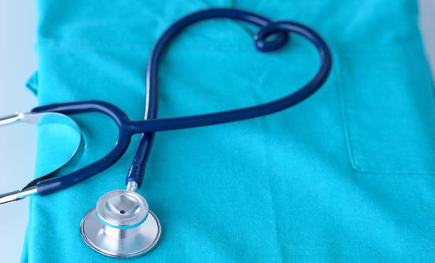 istock A stethoscope shaping a heart on a medical uniform, closeup, selective focus 962678466