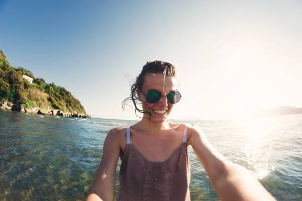 istock Happy woman in summer vacation taking selfie 962682336