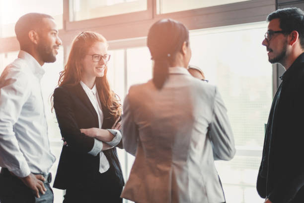 istock Standing business people against office window 962686118