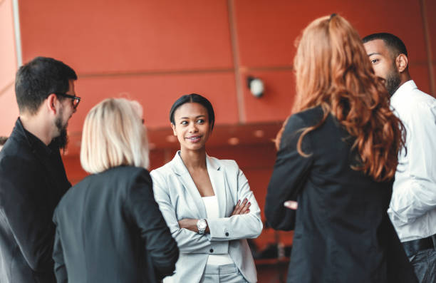 istock Standing group of business people in the office, coffee break 962686490