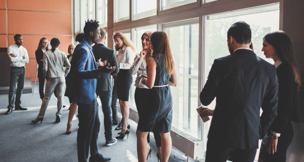 istock Conference room with standing business people 962686628