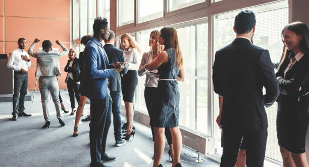 istock Conference room with standing business people 962686714
