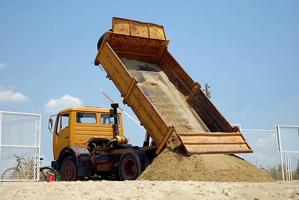 istock Yellow truck dumping sand on the ground 96268925