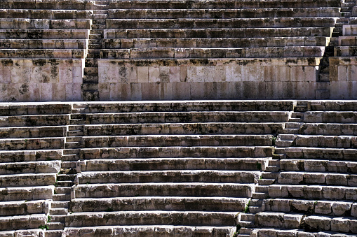 view of seating and stairs in ancient roman ruins in downtown amman, jordan