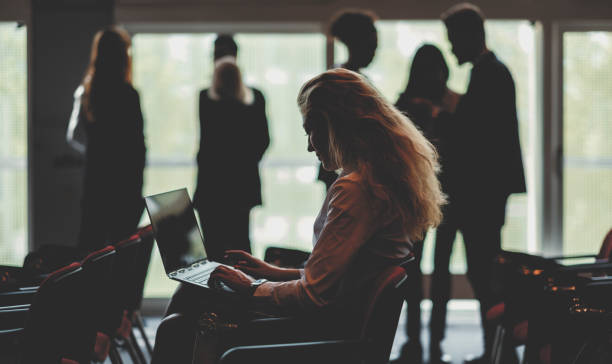 Businesswoman using laptop in conference room