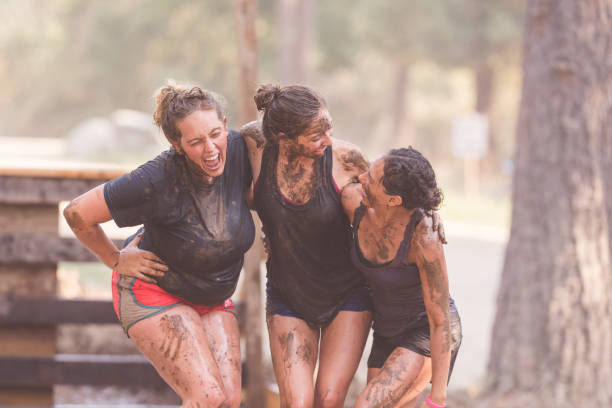 istock Three mud run competitors pose for a picture partway through the race 962693426