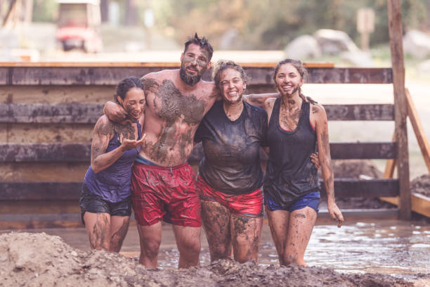 istock Mud run teammates pose for a picture together 962693432