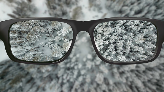 Clear vision through glasses of alpine forest from above
