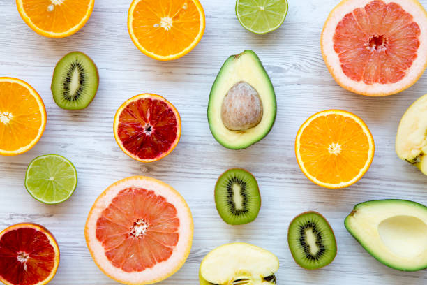 istock Different fresh fruits on white wooden table, top view. Summer background. 962696722
