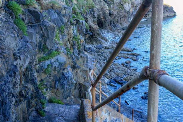 istock Stone Steps Going Down a Rocky Cliffside Leading into the Sea. 962697684