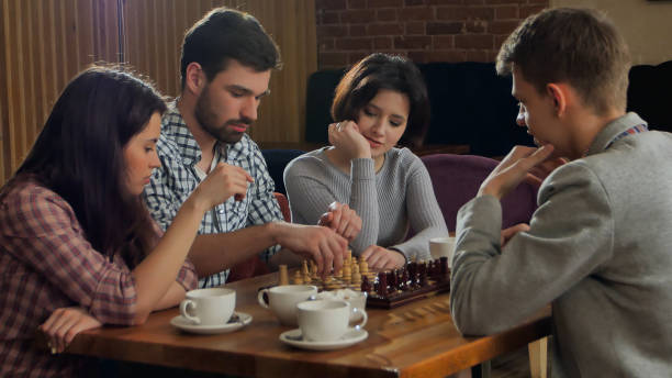 istock Young men and women playing chess 962698238