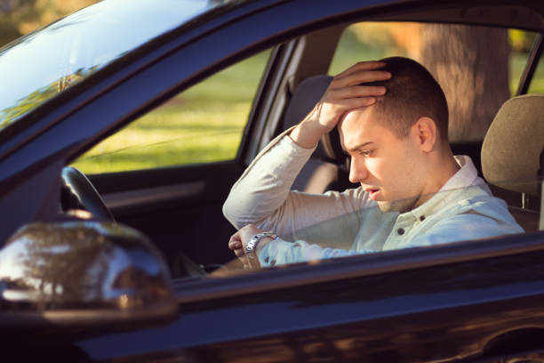 istock Driver looking at the watch in the car and realizing he is late for work 962705534
